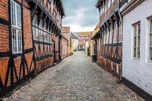 Street with old houses from royal town Ribe in Denmark photo
