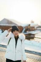 Woman tourist Visiting in Hakodate, Traveler in Sweater sightseeing Kanemori Red Brick Warehouse with Snow in winter. landmark and popular for attractions in Hokkaido,Japan.Travel and Vacation concept photo