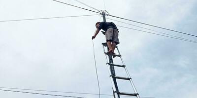 a man is working to repair an unsecured internet network photo