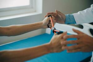 Doctor or physical therapist examines back pain and spinal area to give advice within the rehabilitation center. photo