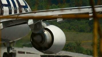 PHUKET, THAILAND NOVEMBER 26, 2016 Close up of Finnair on the runway at Phuket airport, view through the fence video