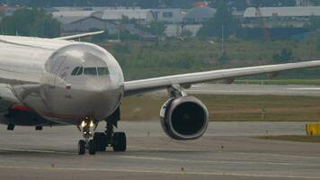 MOSCOW, RUSSIAN FEDERATION JULY 29, 2021 Aeroflot passenger board taxiing at Sheremetyevo, medium shot, front view. Footage plane on the taxiway. Tourism and travel concept video