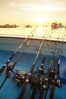 stack of fishing rod on fishing boat photo