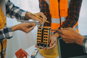 Construction and structure concept of Engineer or architect meeting for project working with partner and engineering tools on model building and blueprint in working site, contract for both companies. photo