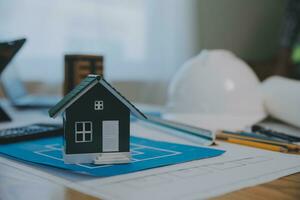 Construction and structure concept of Engineer or architect meeting for project working with partner and engineering tools on model building and blueprint in working site, contract for both companies. photo