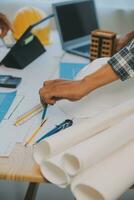 Construction and structure concept of Engineer or architect meeting for project working with partner and engineering tools on model building and blueprint in working site, contract for both companies. photo