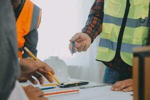 Construction and structure concept of Engineer or architect meeting for project working with partner and engineering tools on model building and blueprint in working site, contract for both companies. photo