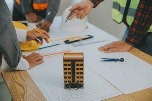 Construction and structure concept of Engineer or architect meeting for project working with partner and engineering tools on model building and blueprint in working site, contract for both companies. photo