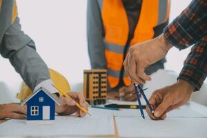 Construction and structure concept of Engineer or architect meeting for project working with partner and engineering tools on model building and blueprint in working site, contract for both companies. photo
