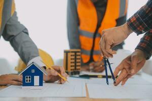 Construction and structure concept of Engineer or architect meeting for project working with partner and engineering tools on model building and blueprint in working site, contract for both companies. photo