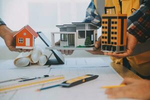Construction and structure concept of Engineer or architect meeting for project working with partner and engineering tools on model building and blueprint in working site, contract for both companies. photo