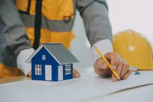 Construction and structure concept of Engineer or architect meeting for project working with partner and engineering tools on model building and blueprint in working site, contract for both companies. photo