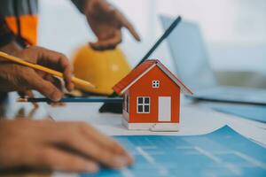 Construction and structure concept of Engineer or architect meeting for project working with partner and engineering tools on model building and blueprint in working site, contract for both companies. photo
