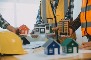 Construction and structure concept of Engineer or architect meeting for project working with partner and engineering tools on model building and blueprint in working site, contract for both companies. photo