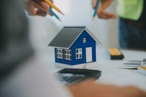 Construction and structure concept of Engineer or architect meeting for project working with partner and engineering tools on model building and blueprint in working site, contract for both companies. photo