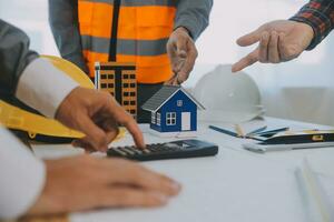 Construction and structure concept of Engineer or architect meeting for project working with partner and engineering tools on model building and blueprint in working site, contract for both companies. photo
