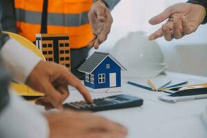 Construction and structure concept of Engineer or architect meeting for project working with partner and engineering tools on model building and blueprint in working site, contract for both companies. photo