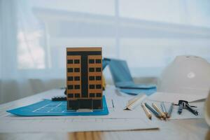 Construction and structure concept of Engineer or architect meeting for project working with partner and engineering tools on model building and blueprint in working site, contract for both companies. photo