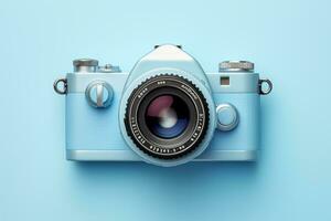 Retro camera isolated on blue background. Top view. Flat lay photo