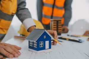 Construction and structure concept of Engineer or architect meeting for project working with partner and engineering tools on model building and blueprint in working site, contract for both companies. photo