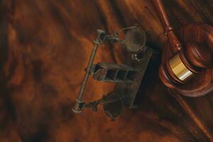 Justice and law concept.Male judge in a courtroom with the gavel, working with, computer and docking keyboard, eyeglasses, on table in morning light photo