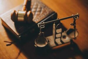 Business and lawyers discussing contract papers with brass scale on desk in office. Law, legal services, advice, justice and law concept picture with film grain effect photo