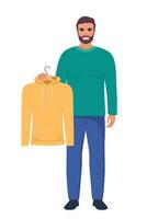 Smiling young man holding hanger with yellow hoody. Choosing clothes concept. Vector illustration in flat style.