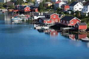 Red and yellow wooden fishing cabins in Norway photo