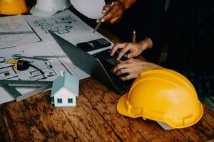 Construction and structure concept of Engineer or architect meeting for project working with partner and engineering tools on model building and blueprint in working site, contract for both companies. photo