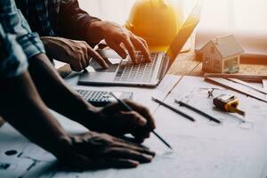 Construction and structure concept of Engineer or architect meeting for project working with partner and engineering tools on model building and blueprint in working site, contract for both companies. photo