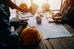 Construction and structure concept of Engineer or architect meeting for project working with partner and engineering tools on model building and blueprint in working site, contract for both companies. photo