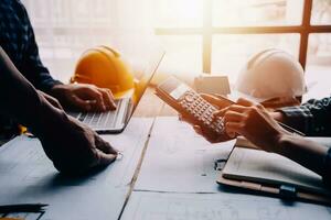 Construction and structure concept of Engineer or architect meeting for project working with partner and engineering tools on model building and blueprint in working site, contract for both companies. photo