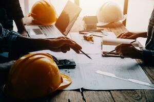 Construction and structure concept of Engineer or architect meeting for project working with partner and engineering tools on model building and blueprint in working site, contract for both companies. photo