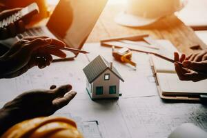 Construction and structure concept of Engineer or architect meeting for project working with partner and engineering tools on model building and blueprint in working site, contract for both companies. photo