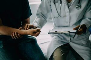 Doctor telling to patient woman the results of her medical tests. Doctor showing medical records to cancer patient in hospital ward. Senior doctor explaint the side effects of the intervention. photo