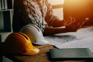 Construction and structure concept of Engineer or architect meeting for project working with partner and engineering tools on model building and blueprint in working site, contract for both companies. photo