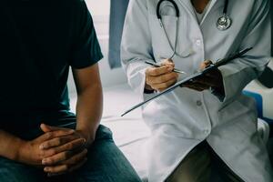 Doctor telling to patient woman the results of her medical tests. Doctor showing medical records to cancer patient in hospital ward. Senior doctor explaint the side effects of the intervention. photo