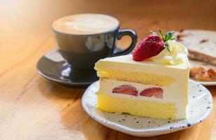 Strawberry cake, vanilla sponge cake with cream cheese and fresh strawberries with hot coffee. photo