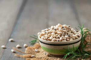 navy bean or white kidneys beans on wood background. photo