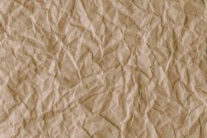 Recycled crumpled brown paper texture background photo