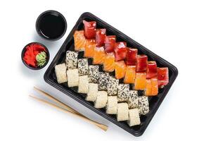 Assorted sushi set with salmon, tuna, seasame served in plastic box takeaway, to go photo