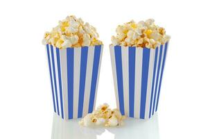 Two blue white striped carton buckets with tasty cheese popcorn, isolated on white background photo