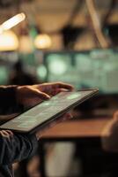 Woman analyzing computer network to hack system on tablet, using code and encrytion to break into security server. Female spy trying to hack database and steal sensitive information. photo