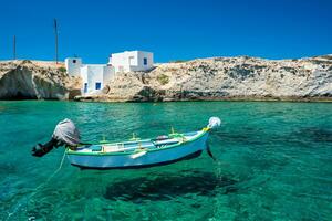 Crystal clear blue water at Mitakas village beach, Milos island, Greece. photo