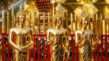 Gold Buddha statues in Wat Phra That Doi Suthep photo