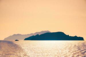 Cyclades islands silhouettes in Aegean sea photo