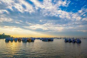 Tourist boats in sea on sunrise in Mumbai, India photo