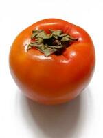 ripe juicy persimmon on a white background photo