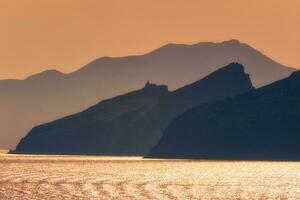 Cyclades islands silhouettes in Aegean sea photo