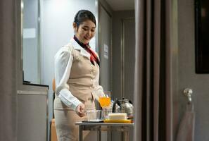 Airplane flight attendant preparing food and drinks for passengers on board. photo